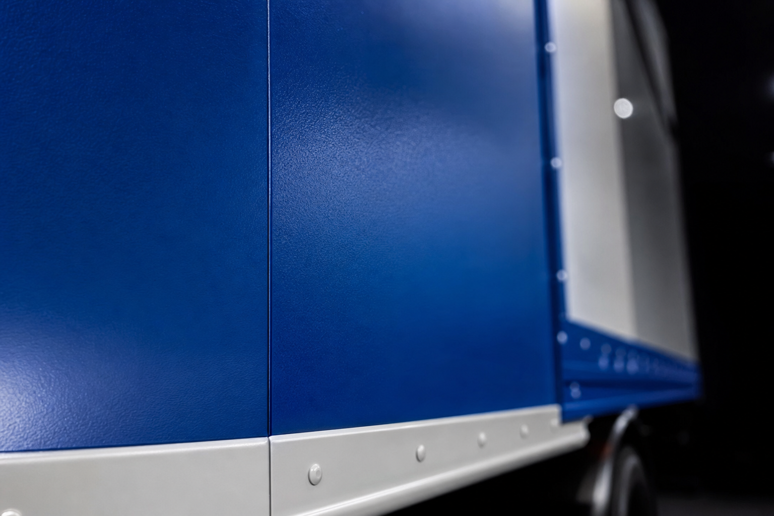 Detail of cast vinyl wrap application on a box truck panel.
